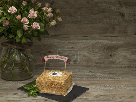 Photo for Birthday cake with writing Happy Birthday. Decorated with large bouquet of roses and copy space - Royalty Free Image