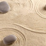 Zen garden with the sand pattern and stones