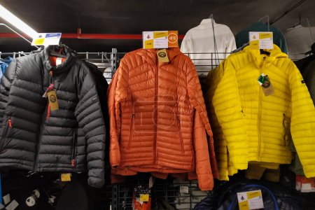 Foto de Colorful men lightweight jackets hanging in mall for sell - Imagen libre de derechos
