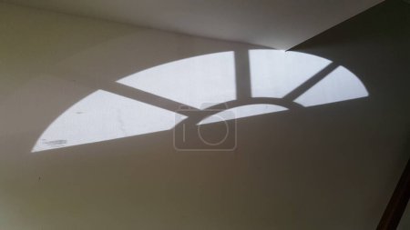Photo for Light from Lunette Window Creates Reflection on a Wall - Royalty Free Image