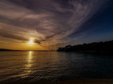 Photo for Mysterious sunset against the background of trees and the bay in Croati - Royalty Free Image