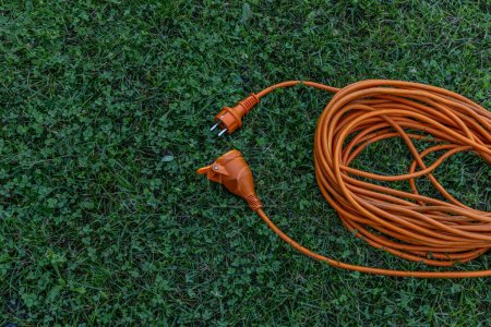 Photo for Electric extension cord and power connection in the garden electrocution - Royalty Free Image