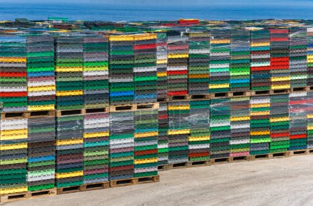 Colorful seafood crates in Croatia, ship for transporting fish and seafood, ship reloading, fish transport crates