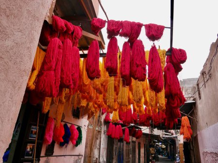 Bundles of orange and red wool hanging to dry at dyers souk, Marrakech, Morocco. High quality photo