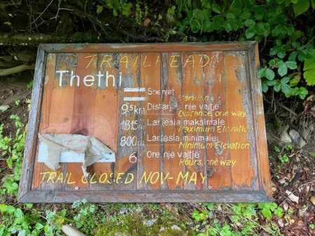 Photo for Close up of wooden sign informing about hike Theth to Valbona, famous trek in the Albanian Alps. High quality photo - Royalty Free Image