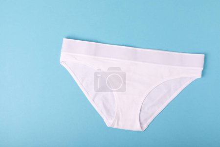Photo for Women's underwear. Different women's underpants on a blue background. A piece of clothing for a person. View from above . place for text. - Royalty Free Image