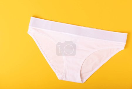 Photo for Women's underwear. Different women's underpants on a yellow background. A piece of clothing for a person. View from above . place for text. - Royalty Free Image