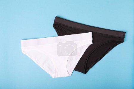 Photo for Women's underwear. Different women's underpants on a blue background. A piece of clothing for a person. View from above . place for text. - Royalty Free Image