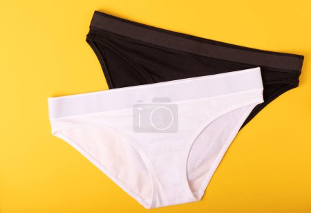 Photo for Women's underwear. Different women's underpants on a yellow background. A piece of clothing for a person. View from above . place for text. - Royalty Free Image
