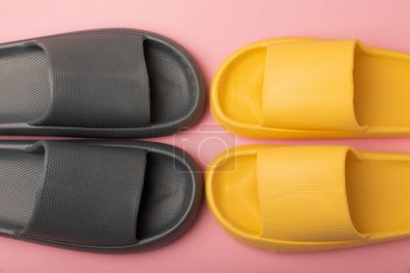 Foto de Home slippers on pink paper background, flat lay. Indoor shoes. Place for text. copy space - Imagen libre de derechos