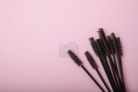 Eyelash brush on a lavender background. Brush for eyelash extension. brush for straightening eyelashes and eyebrows. Makeup. Beauty concept.
