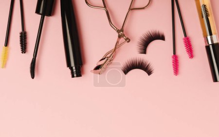 Photo for Composition with eyelash brush, eyelash curler, mascara and false eyelashes on pink background. Flat lay composition. Beauty industry concept.Place for text. Copy Spys. - Royalty Free Image