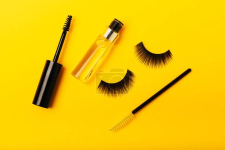 Photo for Gel for the growth of eyelashes and eyebrows. Serums, essential oils or essences for eyelash growth with a strong effect on a yellow background. Place for text. Place to copy. MOCKUP - Royalty Free Image