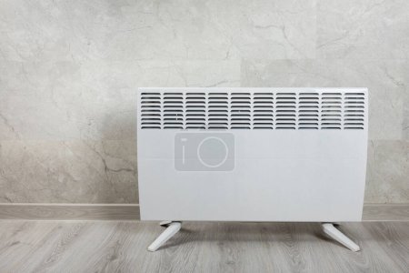 Modern radiator at home. Central heating system.Heating radiator, White radiator in the apartment. Expensive heating costs concept, close-up.Heating season. Heating.Space for text.MOCKUP 