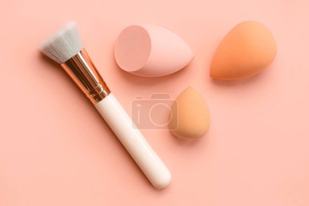 Photo for Makeup buffer brush and beauty makeup sponges over pink background. Beauty and makeup concept - Royalty Free Image