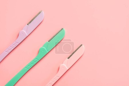 Photo for Top view of different dermaplaning tools with space for text over pink background. Skin care products and beauty concep - Royalty Free Image