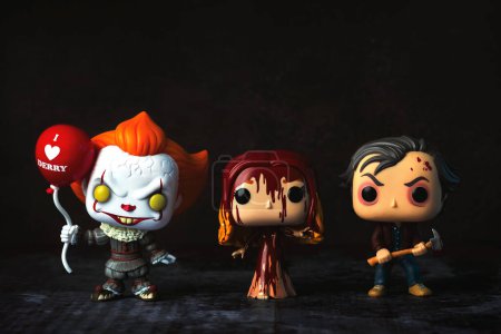 Photo for Funko POP vinyl figures of Pennywise, Carrie and Jack Torrance fictional characters from Stephen King books over grunge background. Illustrative editorial of Funko Pop action figure - Royalty Free Image
