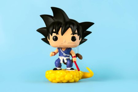 Photo for Funko POP vinyl figure of Son Goku & Flying Nimbus character of the Dragon Ball Z manga series created by Akira Toriyama over blue background. Illustrative editoria - Royalty Free Image