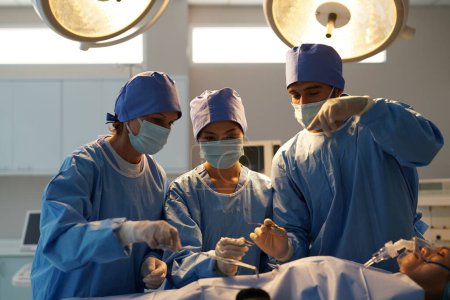 Foto de Cirujanos que trabajan dentro del quirófano - Imagen libre de derechos