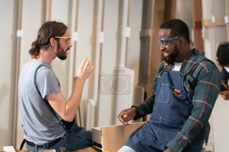 Photo for Manual workers working on a wood in carpentry workshop. - Royalty Free Image