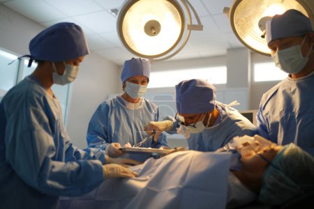 surgeons working inside operating room 