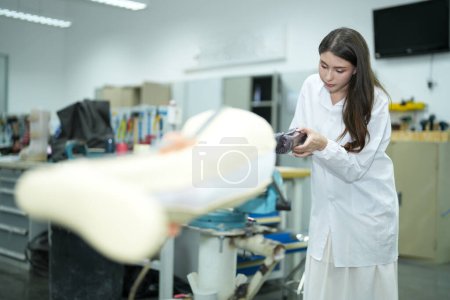 Téléchargez les photos : Technicien orthopédique faisant jambe prothétique pour les personnes handicapées dans l'atelier. - en image libre de droit