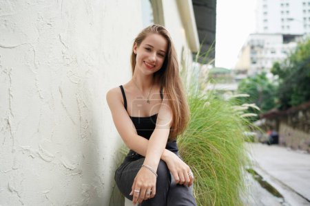 Photo for Young beautiful and attractive woman with long brown hair in a black clothing - Royalty Free Image