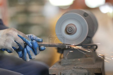 Foto de Primer plano - vista del hombre que trabaja en fábrica con molinillo de metal - Imagen libre de derechos