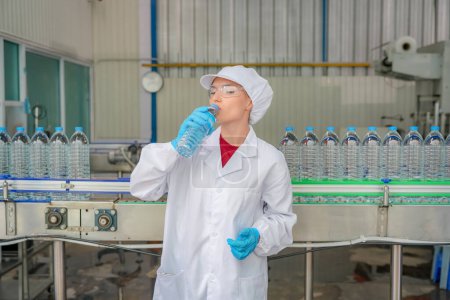 Photo for Woman working at Reverse osmosis system for power plant. RO system for industry, equipment which popular to install with pipe at industrial such chemical, power plant, oil and gas. Young female worker in bottling factory checking water bottles - Royalty Free Image