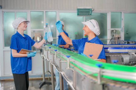 Photo for Women working at Reverse osmosis system for power plant. RO system for industry, equipment which popular to install with pipe at industrial such chemical, power plant, oil and gas. Young  female workers in bottling factory checking water bottles - Royalty Free Image