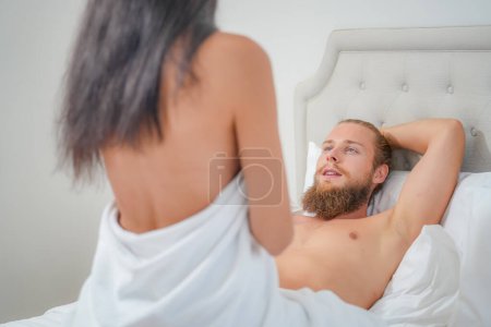 Photo for Passionate foreplay by couple wearing underwear in bedroom. Erotic moments of couple in bed. - Royalty Free Image