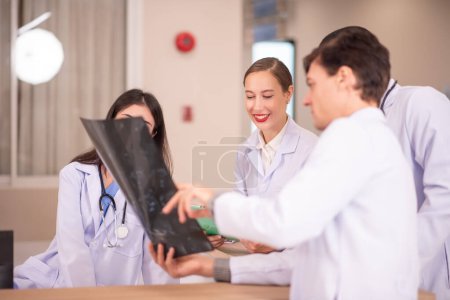 Photo for Doctors examining x-ray in corridor of hospital - Royalty Free Image