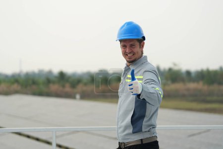 Photo for Electrician engineer with helmet working at a photovoltaic farm, checking and maintenance equipment with instruments at industry solar power. - Royalty Free Image