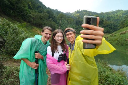 Photo for Young people taking selfie photo, having fun during the hiking in the forest - Royalty Free Image