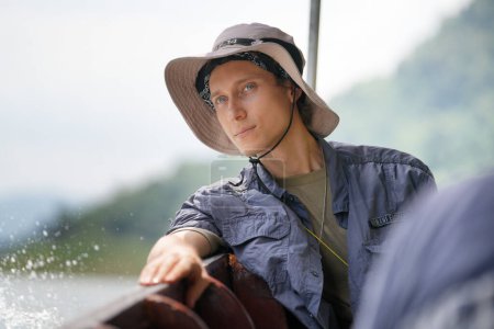 Foto de Excursionista masculino en barco. Aventura, viajes, turismo, senderismo y concepto de personas - Imagen libre de derechos