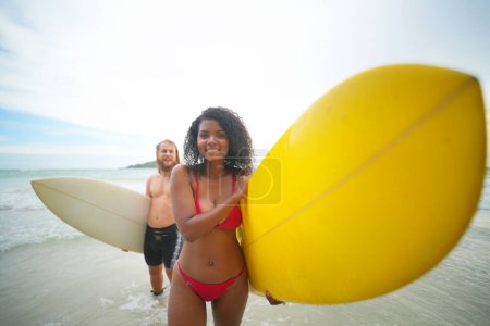 Photo for Happy couple surfing together on beach with surfing board in Pattaya, Thailand. - Royalty Free Image