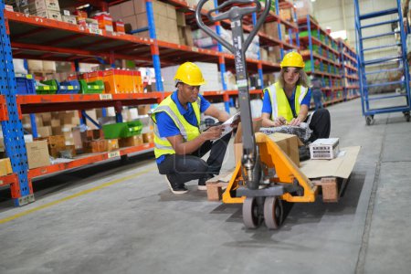 Photo for Workers working in large warehouse. Checking parcels - Royalty Free Image