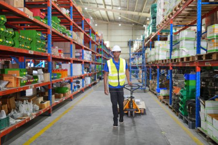 Photo for Male worker working in large warehouse. Checking parcels - Royalty Free Image