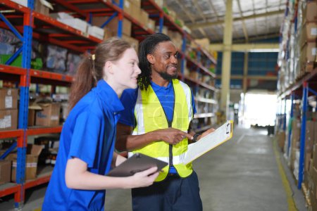 Photo for Workers working in large warehouse. Checking parcels - Royalty Free Image