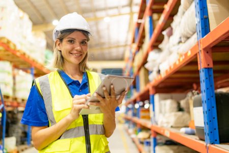 Photo for Worker working in large warehouse. checking parcels - Royalty Free Image