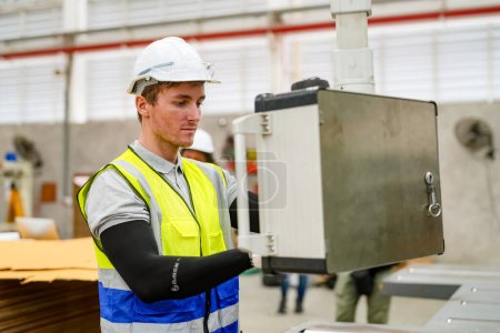 Photo for Industrial worker indoors in factory. Young technician with hard hat. Smart factory worker wearing hardhat and working in power plant - Royalty Free Image