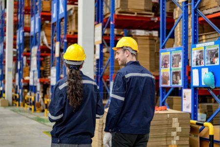 Photo for Warehouse Industrial supply chain and Logistics Companies inside. Warehouse workers checking the inventory. Products on inventory shelves storage. Worker Doing Inventory in Warehouse. Dispatcher in uniform making inventory in storehouse. supply chain - Royalty Free Image