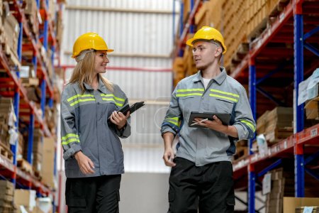 Photo for Warehouse Industrial supply chain and Logistics Companies inside. Warehouse workers checking the inventory. Products on inventory shelves storage. Workers Doing Inventory in Warehouse - Royalty Free Image