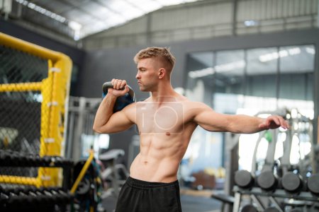 Photo for Young handsome fit man in gym working out - Royalty Free Image