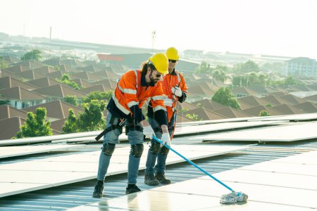 Photo for Professional engineers checking solar roof on factory rooftop under sunlight. Engineers having service job of electrical renewable eco energy - Royalty Free Image