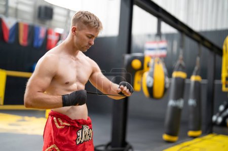 Photo for Caucasian sporty shirtless athlete wearing boxing gloves, doing boxing workout exercise - Royalty Free Image