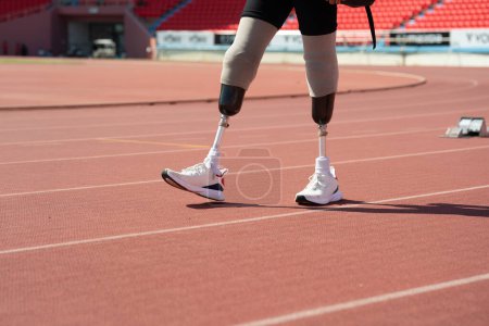 Asian para-athletes with prosthetic blades sprint on a running track at the stadium.