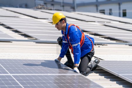 Téléchargez les photos : Ingénieur professionnel vérifiant panneau de toit solaire sur le toit de l'usine sous la lumière du soleil. Ingénieur ayant un emploi de service d'énergie électrique renouvelable éco - en image libre de droit