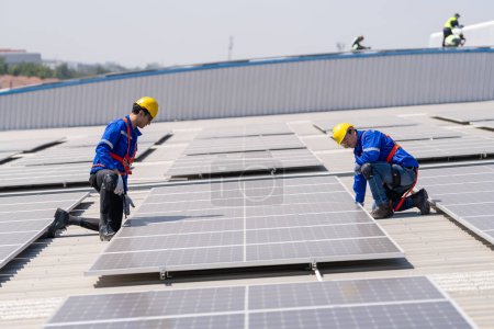 Photo for Professional engineers checking solar roof on factory rooftop under sunlight. Engineers having service job of electrical renewable energy - Royalty Free Image
