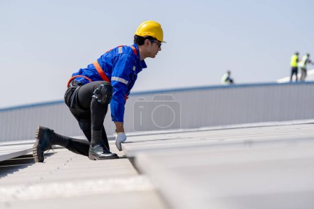 Photo for Professional engineer checking solar roof panel on the factory rooftop under sunlight. Engineer having service job of electrical renewable eco energy - Royalty Free Image